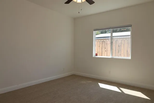 an empty room with a empty space and a window