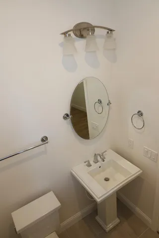 a bathroom with a sink mirror and vanity