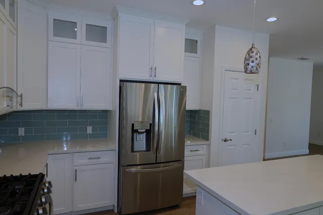 a kitchen with a refrigerator and cabinets