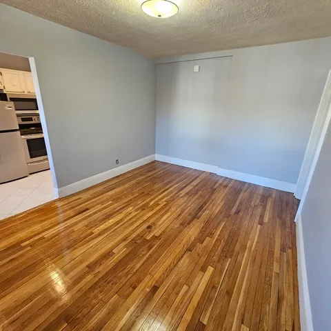 an empty room with wooden floor
