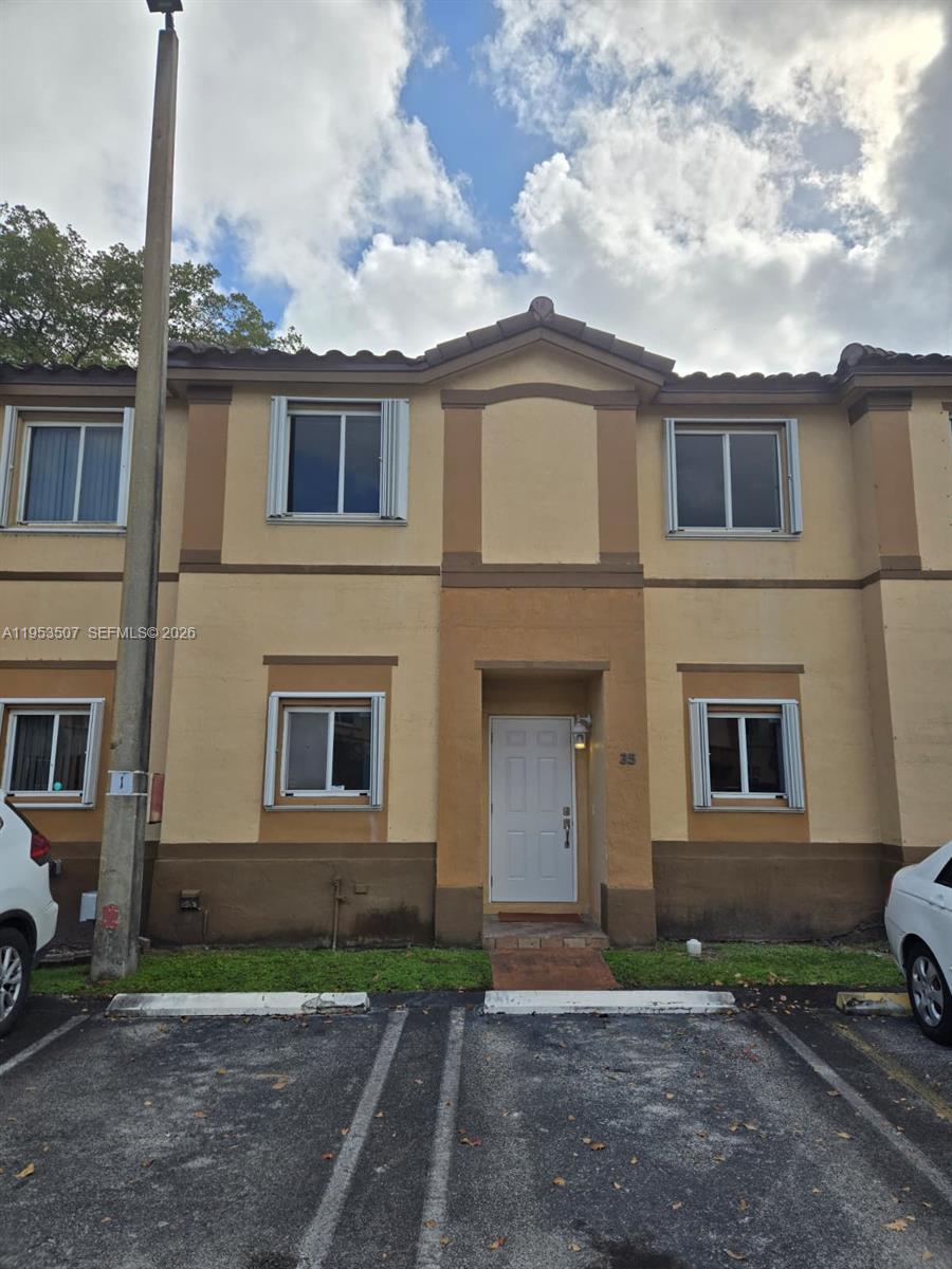 8394 Southwest 152nd Avenue, Unit 35 Miami, FL 33193 - Photo 1 of 24 a front view of a house with garden
