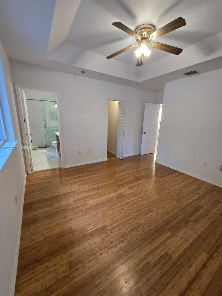 8394 Southwest 152nd Avenue, Unit 35 Miami, FL 33193 - Photo 11 of 24 wooden floor in an empty room with a window