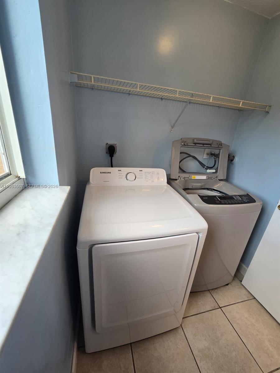8394 Southwest 152nd Avenue, Unit 35 Miami, FL 33193 - Photo 21 of 24 a utility room with dryer and washer