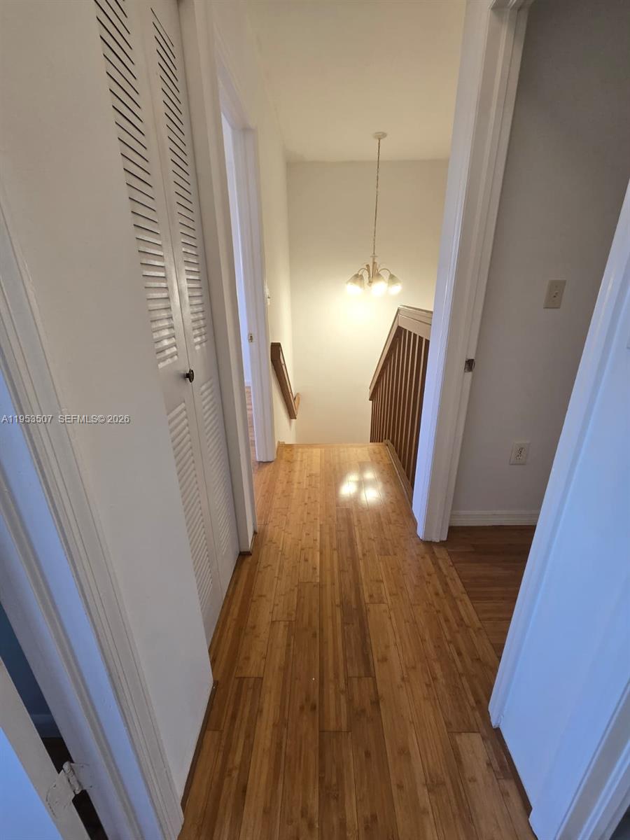 8394 Southwest 152nd Avenue, Unit 35 Miami, FL 33193 - Photo 10 of 24 a view of a hallway with wooden floor and staircase
