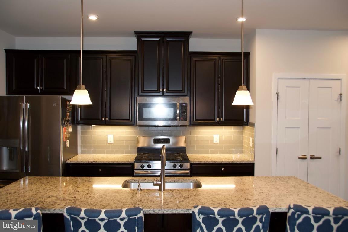 2101 Hemlock Bay Road Dumfries, VA 22026 - Photo 6 of 35 Dark Rich cabinets with center island kitchen