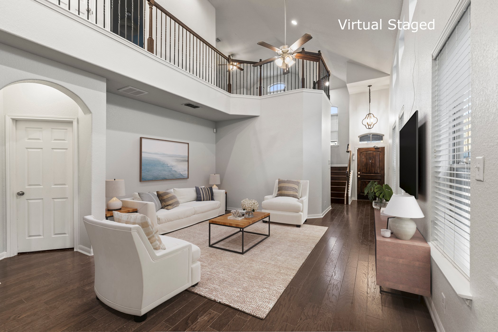 7337 Menchaca Road, Unit #22 Austin, TX 78745 - Photo 13 of 25 Living room featuring wood-type flooring, stairway, ceiling fan, a towering ceiling, and arched walkways