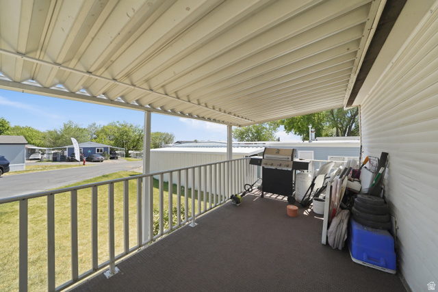 160 Cushing Way Layton, UT 84041 - Photo 3 of 23 Covered outdoor deck with metal railing, offering extended exterior living space