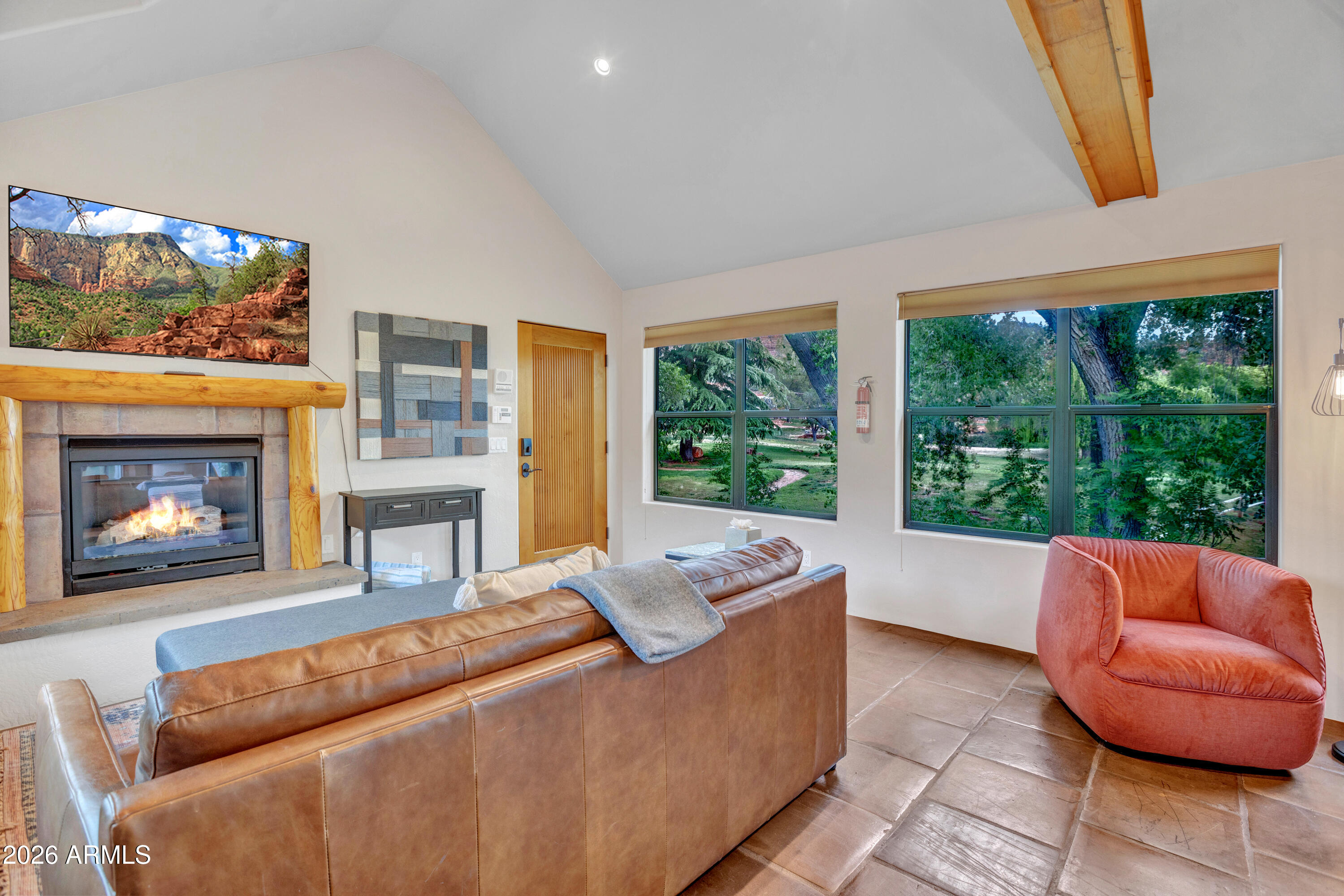 55 Ranch House Circle Sedona, AZ 86336 - Photo 46 of 61 a living room with furniture a fireplace and a floor to ceiling window