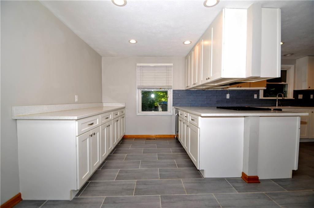603 Meade Drive Coraopolis, PA 15108 - Photo 13 of 41 a kitchen with a sink stove and cabinets