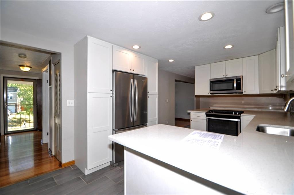 603 Meade Drive Coraopolis, PA 15108 - Photo 15 of 41 a kitchen with stainless steel appliances a refrigerator a stove a sink and a microwave