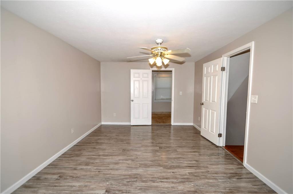 603 Meade Drive Coraopolis, PA 15108 - Photo 22 of 41 a view of an empty room with chandelier fan and wooden floor