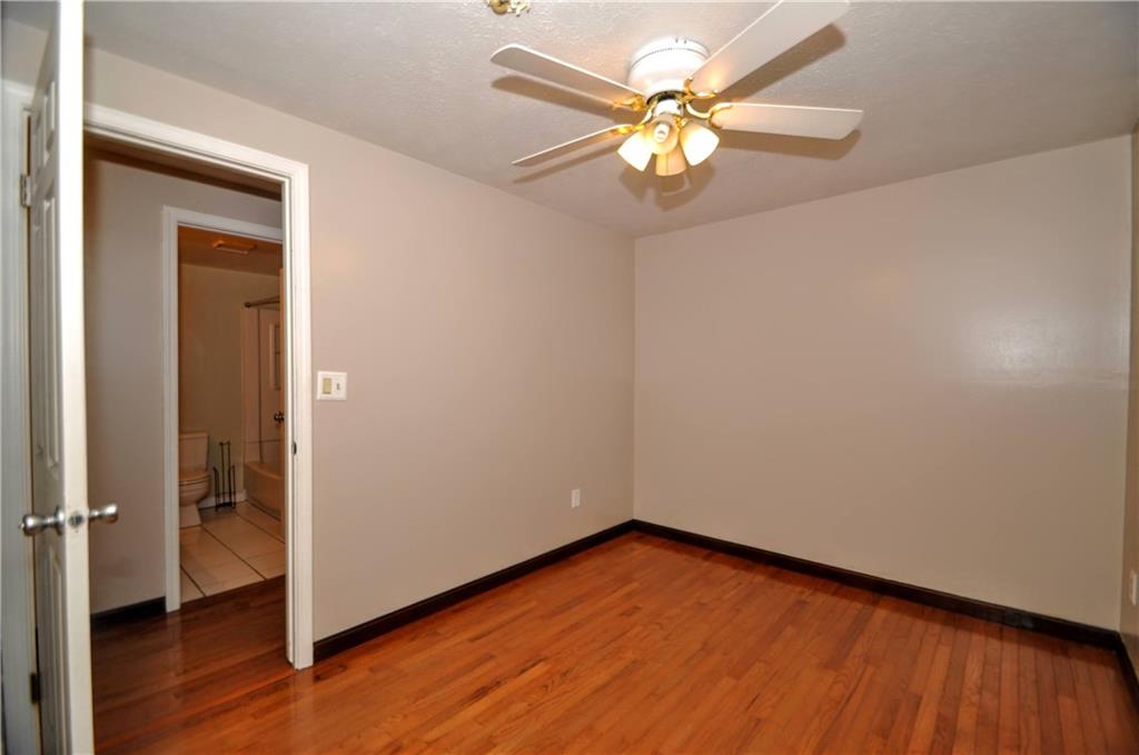 603 Meade Drive Coraopolis, PA 15108 - Photo 27 of 41 an empty room with wooden floor fan and windows