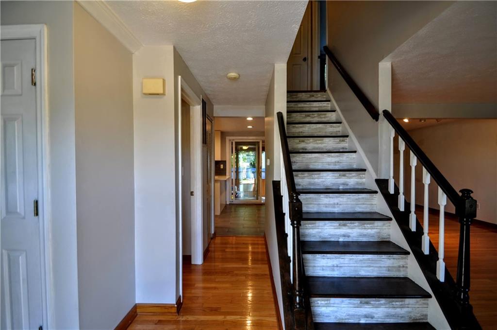 603 Meade Drive Coraopolis, PA 15108 - Photo 7 of 41 a view of staircase with wooden floor and a chandelier