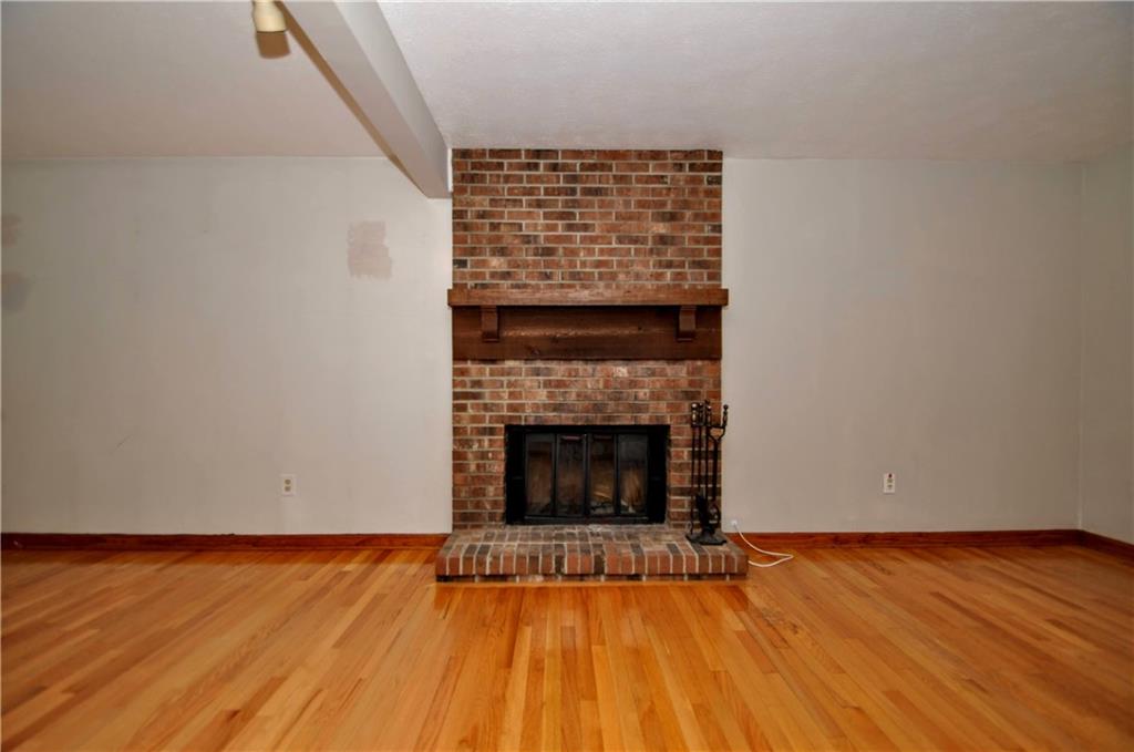 603 Meade Drive Coraopolis, PA 15108 - Photo 8 of 41 a view of an empty room with wooden floor and a fireplace