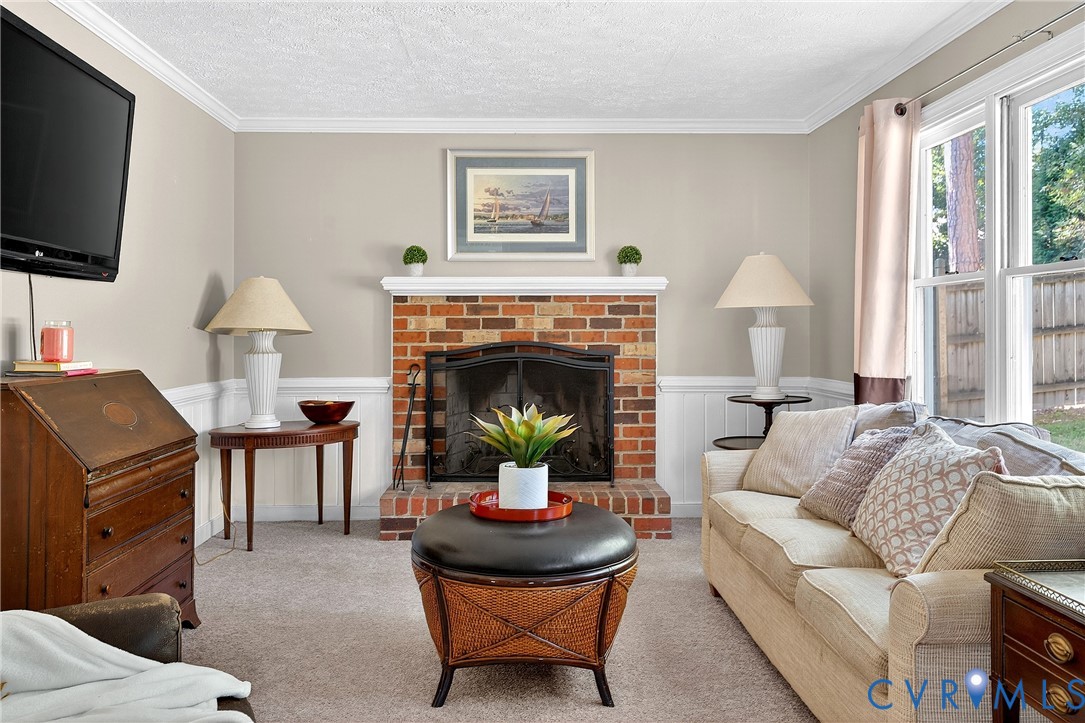12831 Ashtree Road Midlothian, VA 23114 - Photo 17 of 45 a living room with furniture a fireplace and a flat screen tv