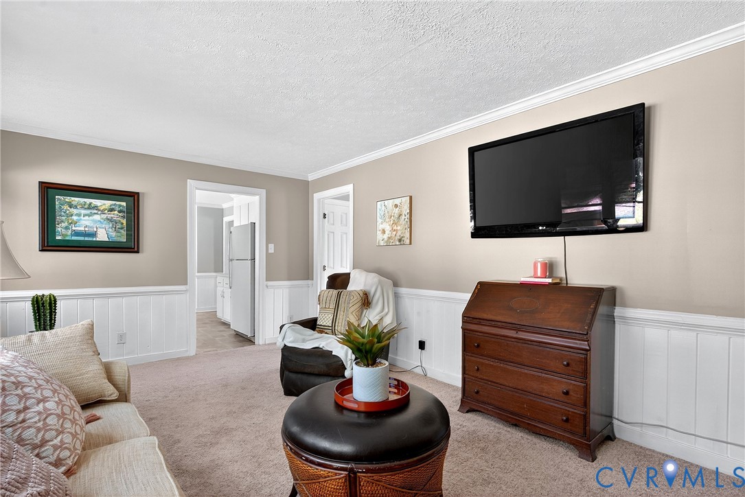 12831 Ashtree Road Midlothian, VA 23114 - Photo 19 of 45 a living room with furniture and a flat screen tv