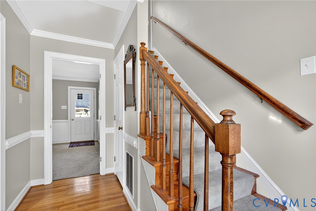 12831 Ashtree Road Midlothian, VA 23114 - Photo 23 of 45 a view of a hallway with wooden floor and staircase