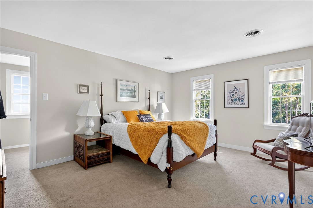 12831 Ashtree Road Midlothian, VA 23114 - Photo 24 of 45 a spacious bedroom with a bed and window