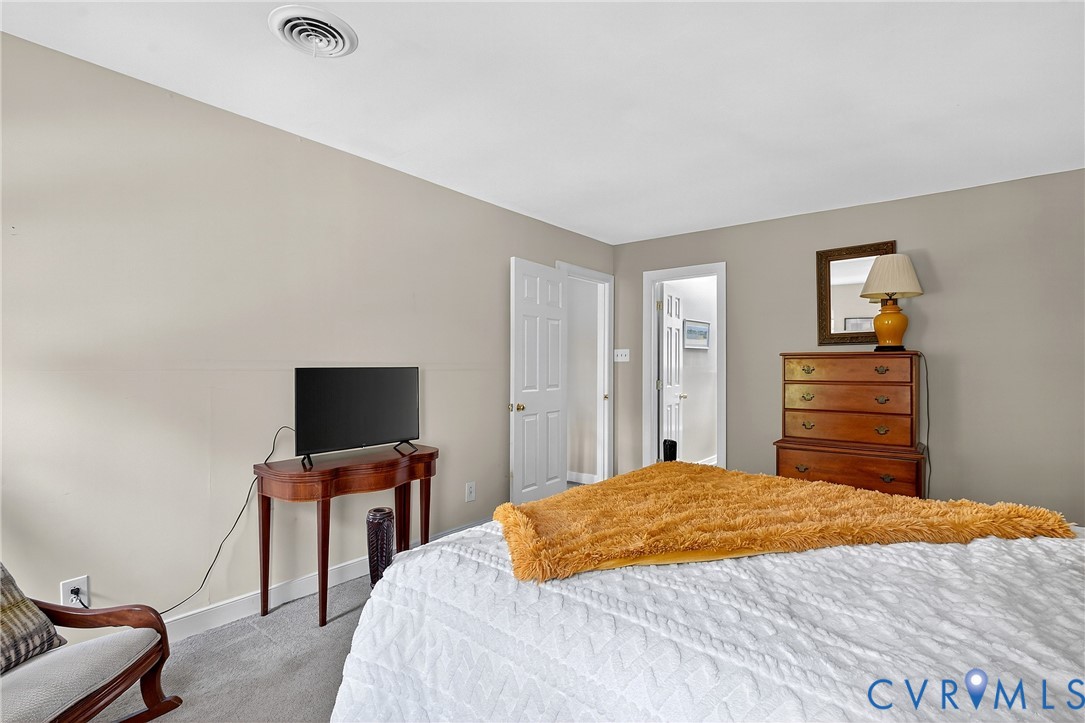 12831 Ashtree Road Midlothian, VA 23114 - Photo 25 of 45 a bedroom with a bed and a flat screen tv
