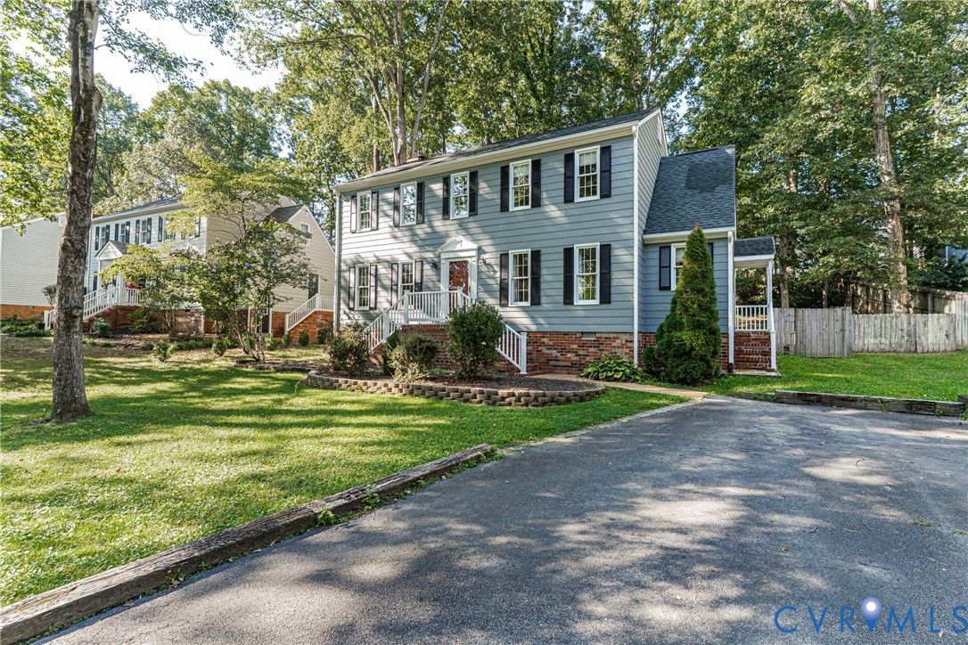 12831 Ashtree Road Midlothian, VA 23114 - Photo 3 of 45 a front view of house with yard and green space