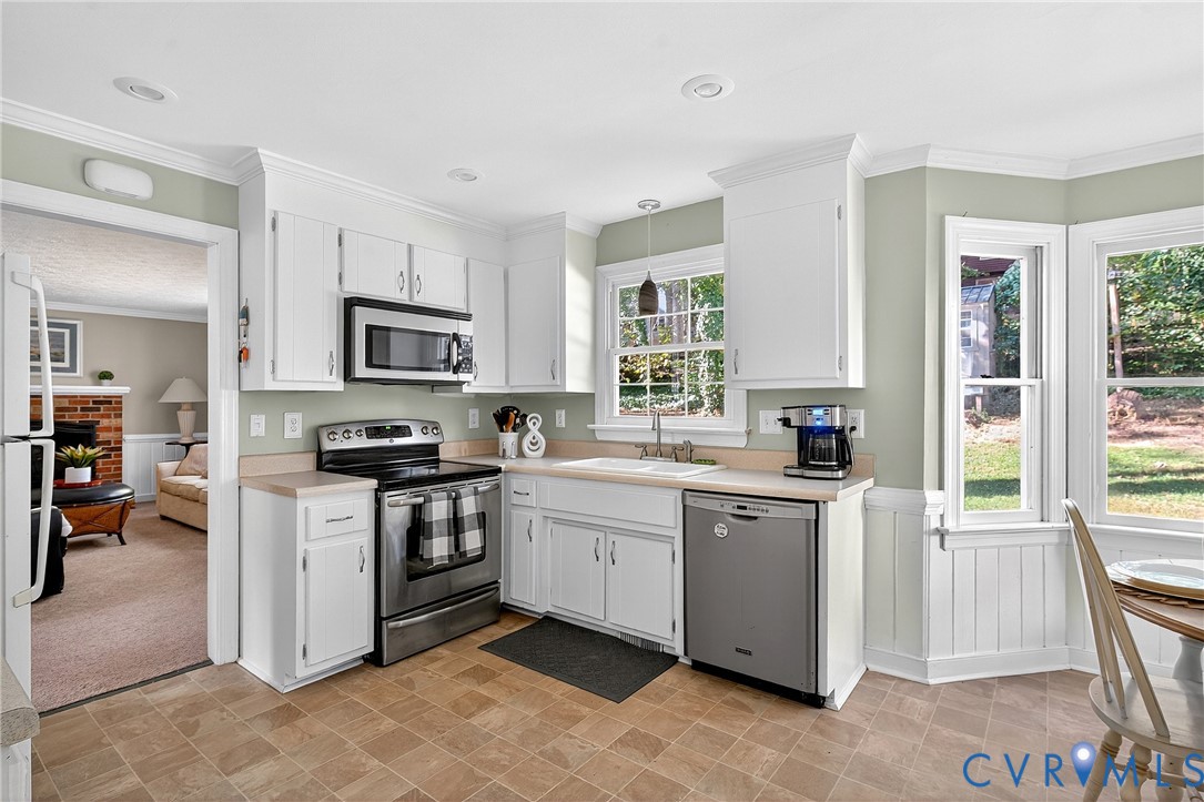 12831 Ashtree Road Midlothian, VA 23114 - Photo 8 of 45 a kitchen with a sink stove and microwave