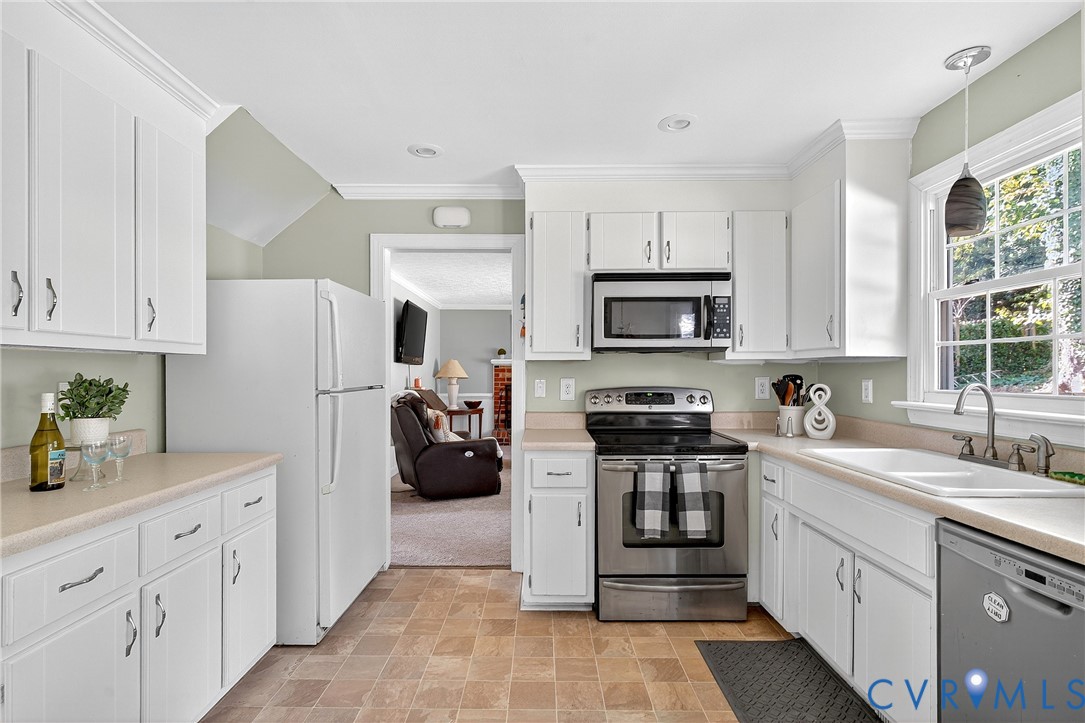 12831 Ashtree Road Midlothian, VA 23114 - Photo 9 of 45 a kitchen with white cabinets and appliances