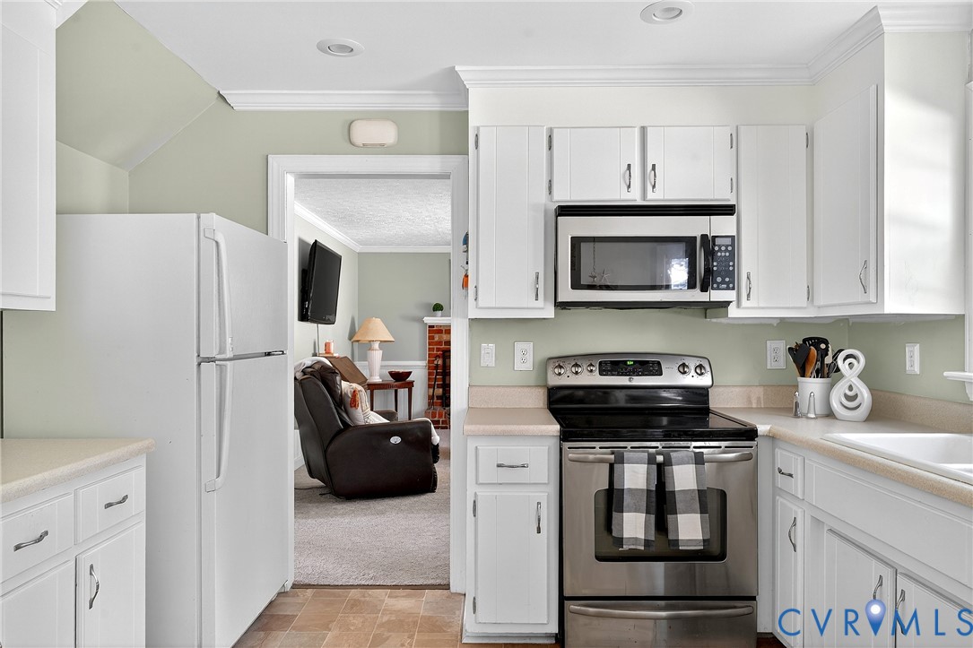 12831 Ashtree Road Midlothian, VA 23114 - Photo 10 of 45 a kitchen with a refrigerator and a stove top oven