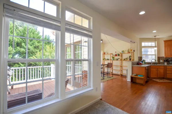 a view of a living room and dining room with wooden floor