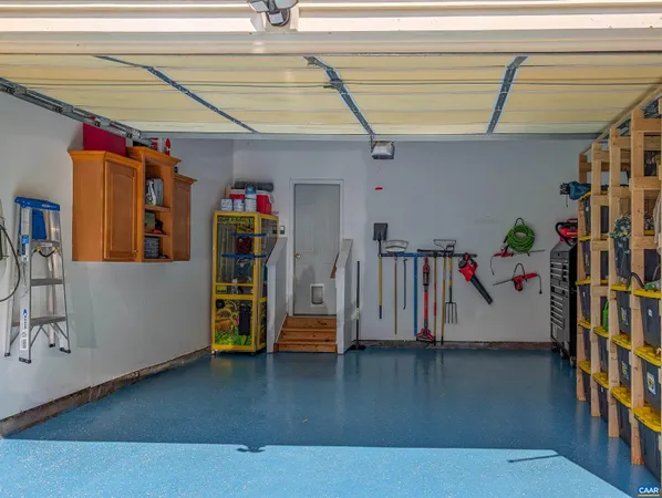 a bedroom with a bed a chandelier and a window