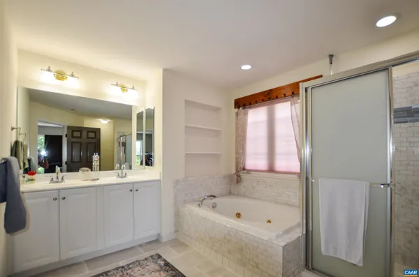 a bedroom with a bed and a flat tv screen