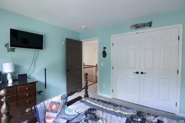 a bedroom with furniture and a window