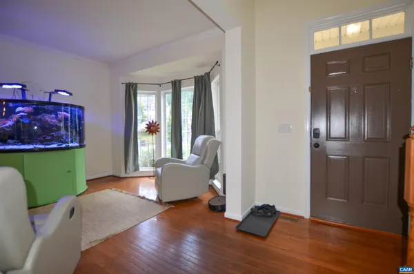 a living room with window and a wooden floor