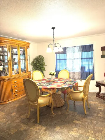 a dining room with furniture and chandelier