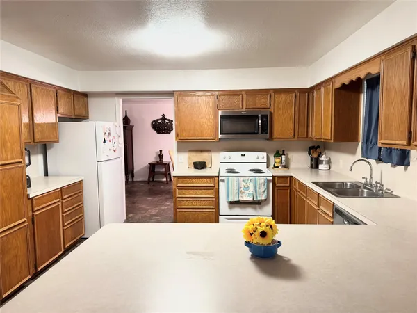 a kitchen with stainless steel appliances a refrigerator stove and a sink
