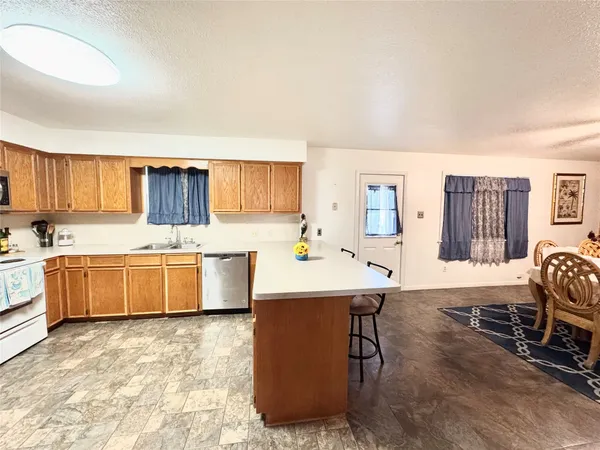 a large kitchen with a table and chairs in it