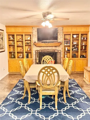 a view of a dining room with furniture a rug and wooden floor