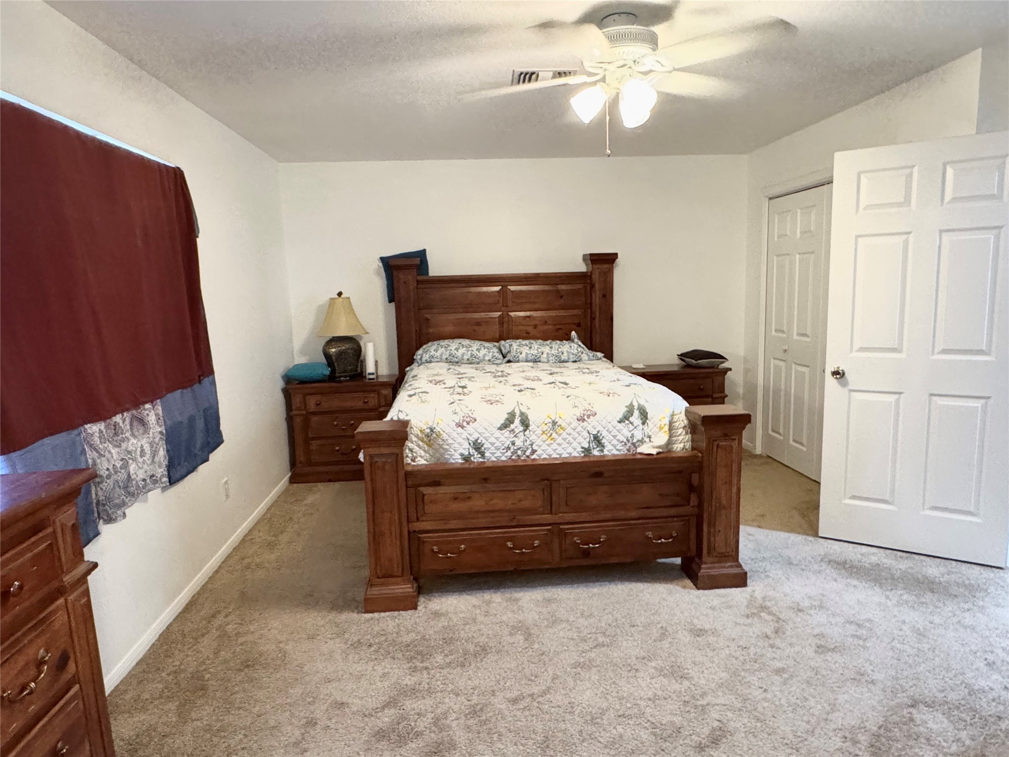 12420 Old Needville Fairchild Road Needville, TX 77461 - Photo 21 of 26 a bedroom with a bed and a chandelier