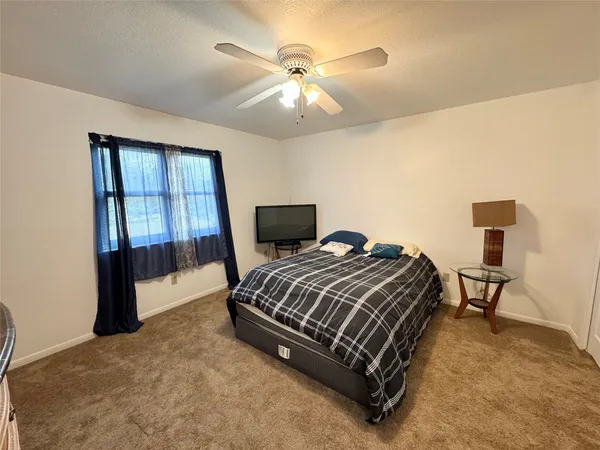 a bedroom with a bed and window