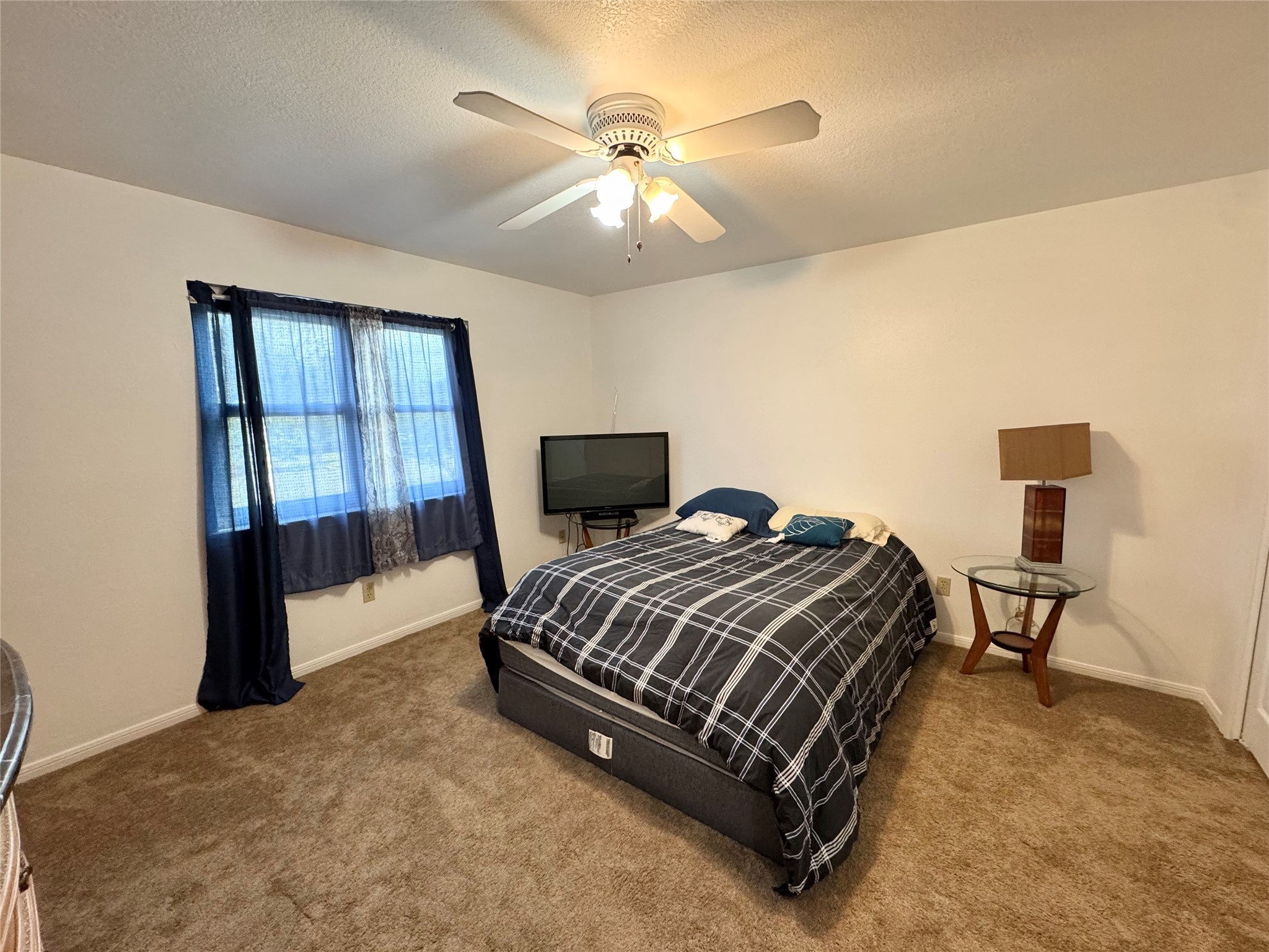 12420 Old Needville Fairchild Road Needville, TX 77461 - Photo 24 of 26 a bedroom with a bed and window