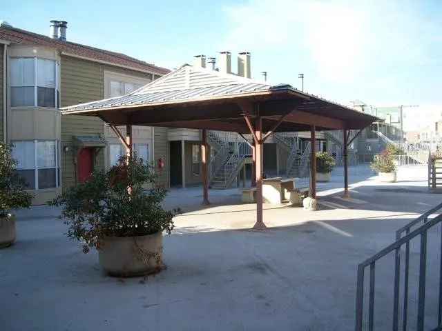 a view of a patio with table and chairs potted plants
