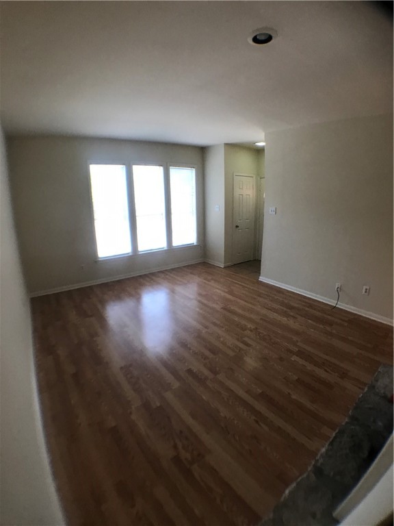 2529 Rio Grande Street, Unit 9 Austin, TX 78705 - Photo 6 of 18 an empty room with wooden floor and windows