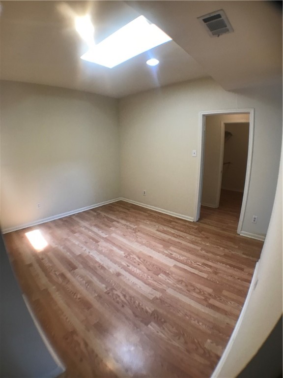2529 Rio Grande Street, Unit 9 Austin, TX 78705 - Photo 7 of 18 an empty room with wooden floor and windows