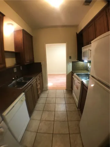 a kitchen with a sink a counter top space and cabinets