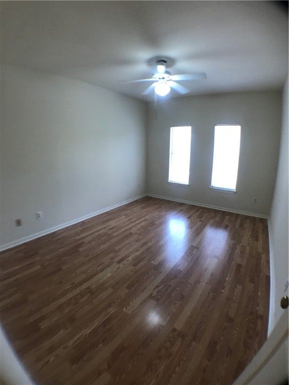 2529 Rio Grande Street, Unit 9 Austin, TX 78705 - Photo 10 of 18 an empty room with wooden floor and windows
