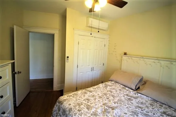 a bedroom with a bed and a shower