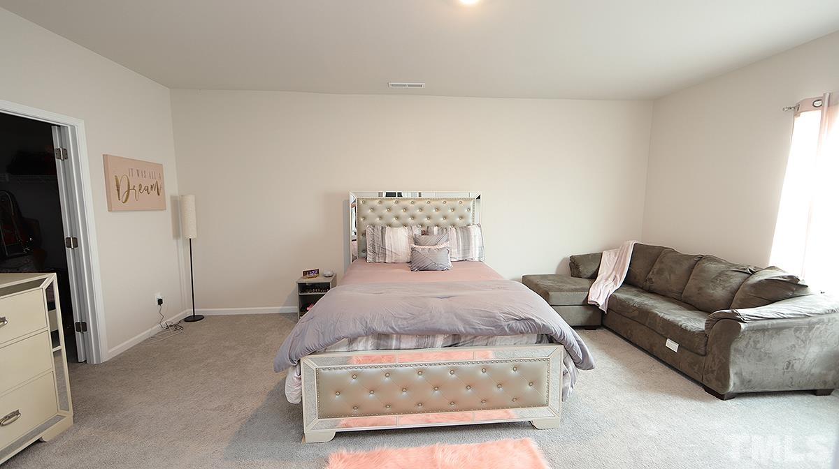3705 Putman Road Raleigh, NC 27610 - Photo 13 of 19 a bedroom with bed and furniture