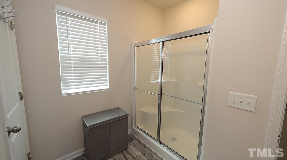 3705 Putman Road Raleigh, NC 27610 - Photo 15 of 19 a bathroom with a shower and a window