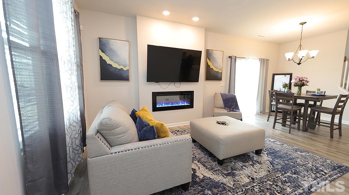 3705 Putman Road Raleigh, NC 27610 - Photo 5 of 19 a living room with furniture fireplace and a flat screen tv
