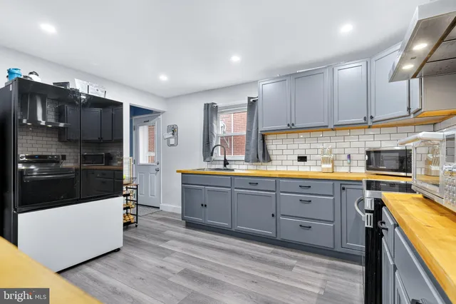a kitchen with cabinets a sink and appliances