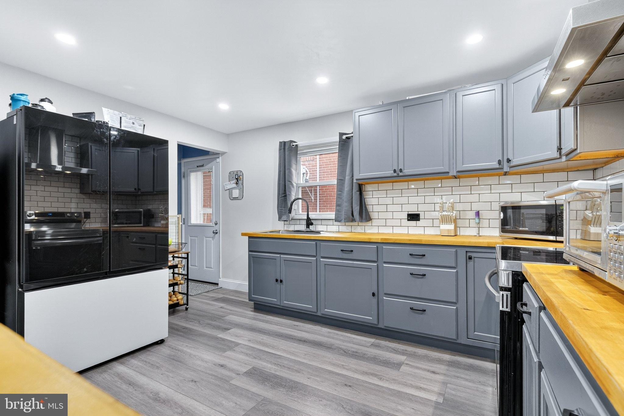 a kitchen with cabinets a sink and appliances